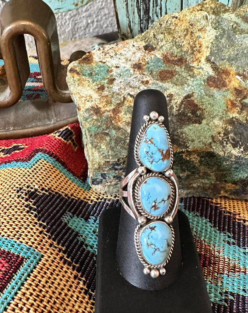 Golden Hills Turquoise Three Stone Ring by Navajo artist E.M. Linkin - front view on ring stand