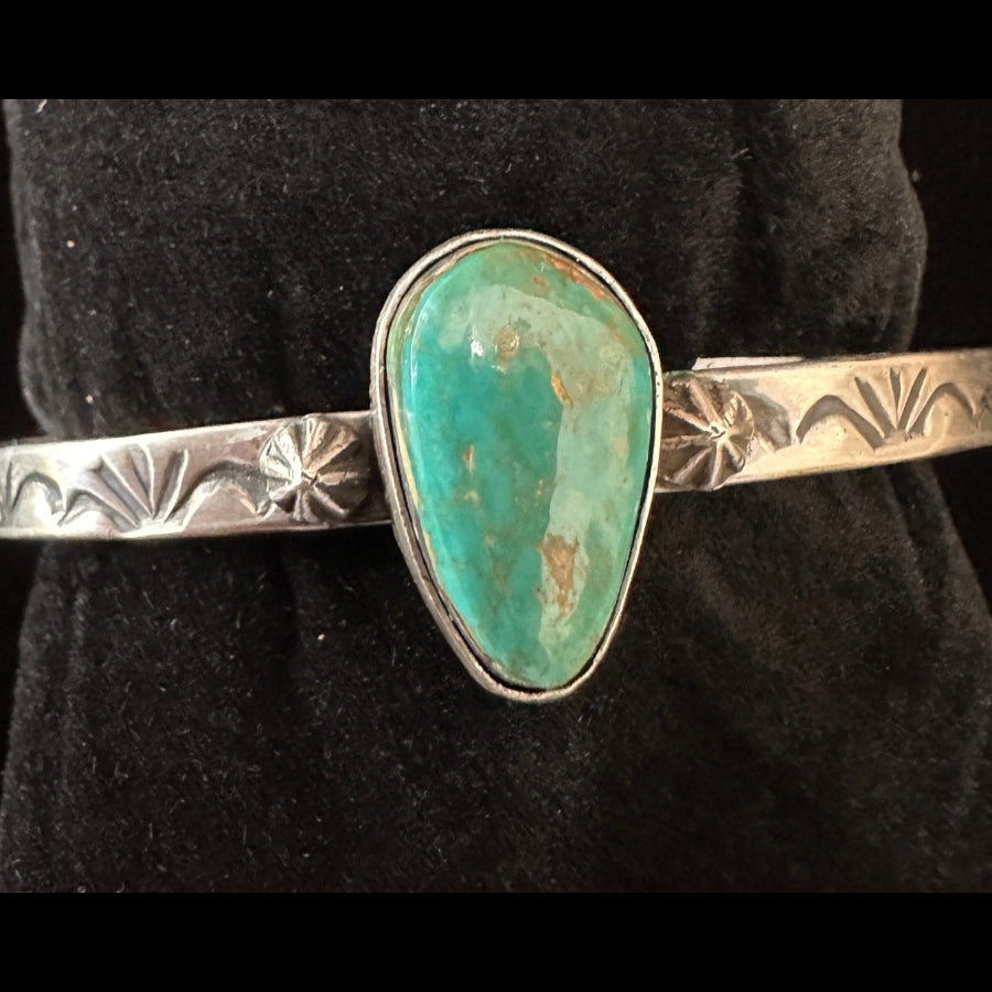 Navajo sterling silver teardrop turquoise cuff bracelet with star shot detailing – top view Tahe